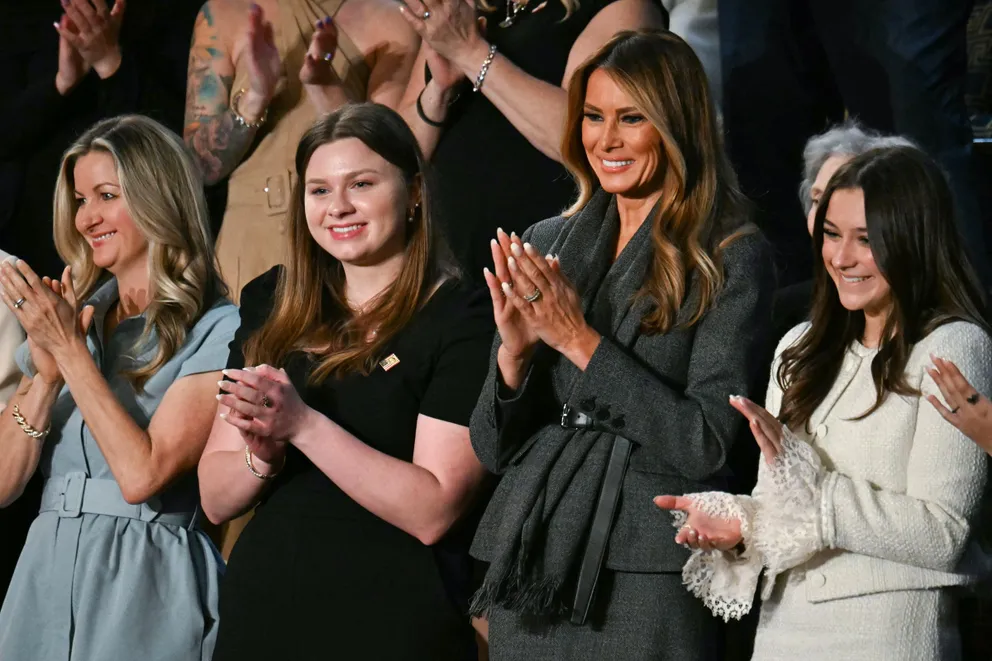 Melania Trump clapping and smiling alongside other women during Donald Trump's address to Congress in Washington, D.C., on March 4, 2025. | Source: Getty Images