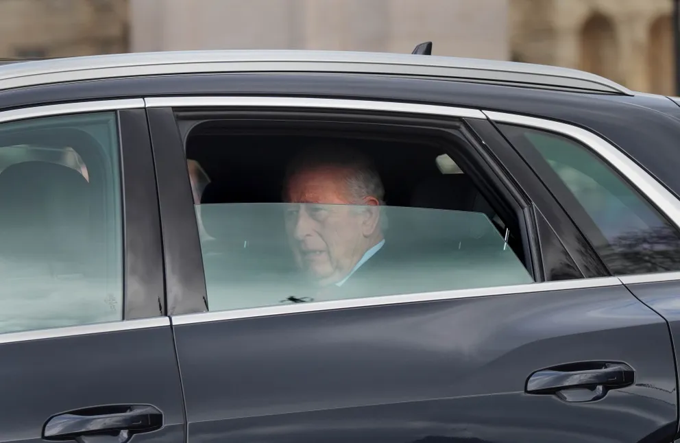 King Charles III sitting in the backseat of the black Audi. | Source: Getty Images